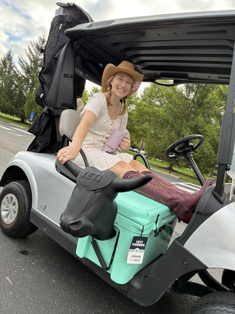 Hallie riding with the bucking bull cooler at OCUF golf